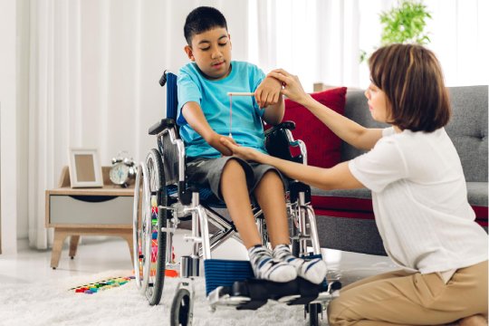 Lady NDIS Support Worker Helping to the Disabled Guy for playing
