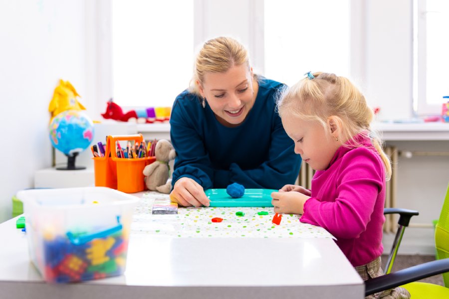 Lady Therapist is doing children's therapy.